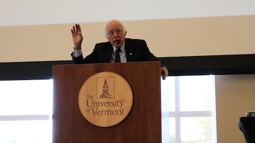 Senator Sanders speaking at podium at the UVM Climate Summit